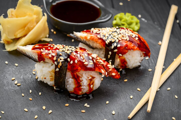 nigiri sushi with eel on black background