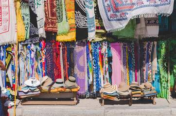 Fototapeta na wymiar Colorful market with many articles of clothing and hats