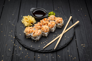 Sushi set nigiri and sushi rolls served on black stone slate