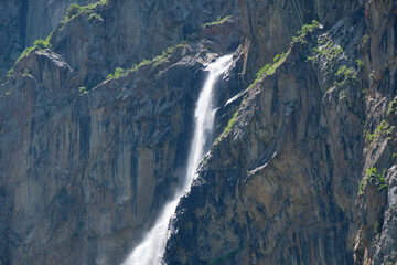 high in the mountains waterfall on the rocks