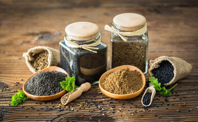 Fresh cumin seeds and powder on the wooden table