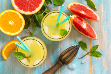Summer menu drink. Orange and Grapefruit  refreshing drink with ice. Top view flat lay background.