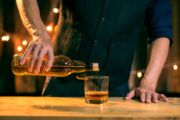 Barman pouring whiskey whiskey glass beautiful night