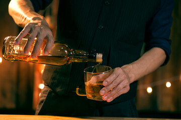 Barman pouring whiskey whiskey glass beautiful night