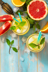 Summer drink. Orange and Grapefruit  refreshing drink with ice. Top view flat lay background. Copy space.