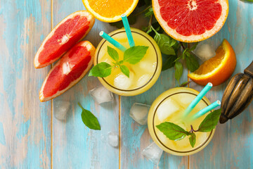 Summer drink. Orange and Grapefruit  refreshing drink with ice. Top view flat lay background. Copy space.