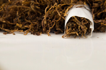 macro photo of hand rolled tobacco in its leaves. there is space in the photo for text.	