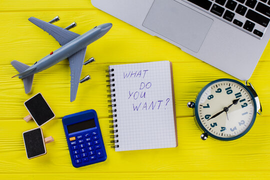 Flat lay abstract concept of dreams and goals. What do you want quote on the notepad. Yellow wooden background. - Powered by Adobe