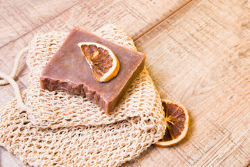cocoa soap made from natural ingredients on a knitted washcloth, homemade soap and slices of dried...