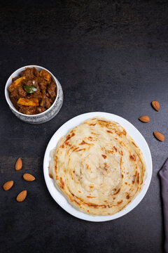 Kerala parathas / porotta / roti / parotta / barotta/ naan layered flatbread made from maida or whole wheat flour. Eat with spicy Asian chicken or beef or egg curry gravy. breakfast dish. Indian food.