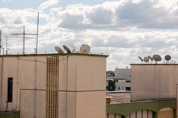 TV Satellite dishes sitting atop apartment buildings 