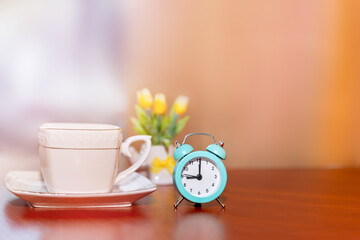 Start up concept. Coffee cup, vintage alarm clock, morning coffee day start.