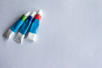 three tubes with paints
