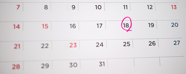 Red circle mark at 18th on calendar date business planning appointment meeting concept