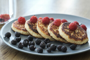 Homemade cheesecakes with blueberries and raspberries.
