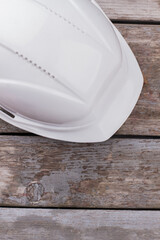 Fototapeta na wymiar Builder worker helmet on wooden table. Top view close up.