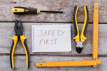 Constructor accessories and slogan safety first. Pliers with ruler and screwdriver top view flat...