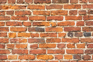 Wall with old worn vintage bricks