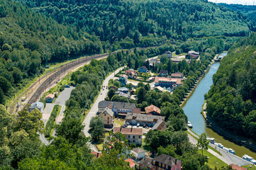 Fototapeta na wymiar Panoramic view of the Zorn valley, village of Lutzelbourg. In this narrow valley, the river, the canal, the national road and the railway pass by.