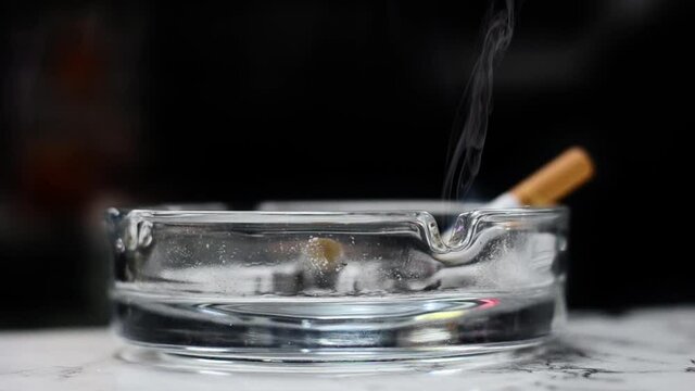 a cigarette is placed in an ashtray