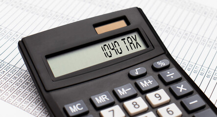 A calculator with the word 1040 TAX on the display