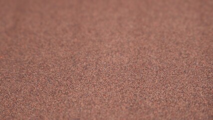 brown paper or fabric base with a grain texture of a flat surface and a slight blur at the edges, texture background for design