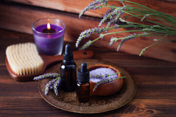 herbal essential oil bottles and fresh lavender flowers