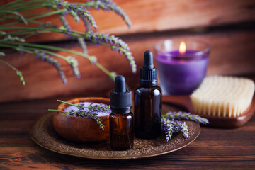 herbal essential oil bottles and fresh lavender flowers