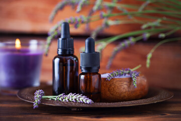 Fototapeta na wymiar herbal essential oil bottles and fresh lavender flowers