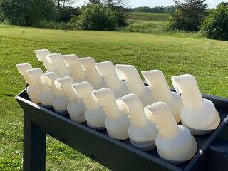 Containers of sand are ready for golfers to place on their carts, as they are encouraged to fill in...