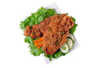 Wiener Schnitzel breaded and served with fresh vegetables on the wooden board. Isolated object