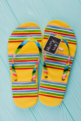 Bright sandals on a blue background. Flat lay compostion.