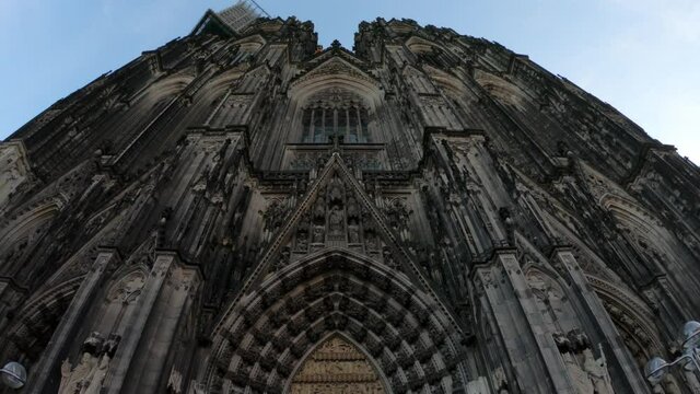 SLOW MOTION SHOT - Entrance gate to the Cologne Cathedral (Kolner Dom), Roman Catholic cathedral church, located in the city of Koln, Germany. It is the largest Gothic church in northern Europe.