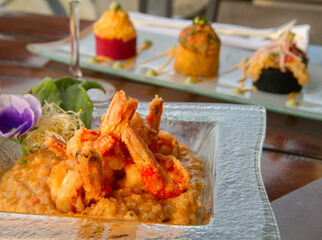 Gourmet seafood. Elegant restaurant and dish presentation. Fried shrimps over mediterranean risotto. 