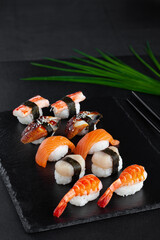 Close-up set of nigiri sushi with fresh shrimp, salmon, scallop, smoked eel