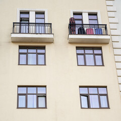 Direct view of the facade of a modern apartment building with balconies.