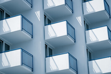 Building with evenly protruding white-blue balconies, Side view