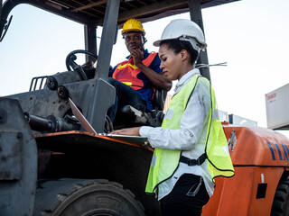 Two person foreman engineering helmet wear yellow and white safety green red are working computer pc notebook tablet and talk smartphone about import export investment technology digital at warehouse