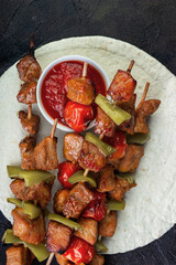 Barbecue pork with vegetables and ketchup on pita bread