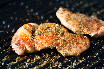 Grilled chicken in a grill with spice.