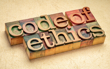 code of ethics word abstract in letterpress wood type printing blocks stained by color inks, values, ethical principles, and ethical standards concept