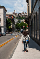 Young Attractive Woman Walking One of Central Streets Towards Upper City in Bergamo, Lombardy, Italy