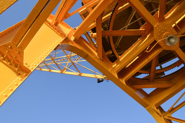 Bottom-up picture of one of the old cranes  in Dock Station. They have been restored and painted yellow.