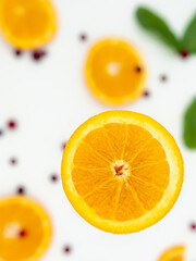 slice of orange with cranberries and mint on the background