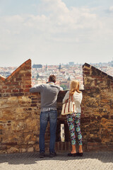 young couple in love walking on a street of European city. sightseeing traveler. Prague, Czech Republic.
