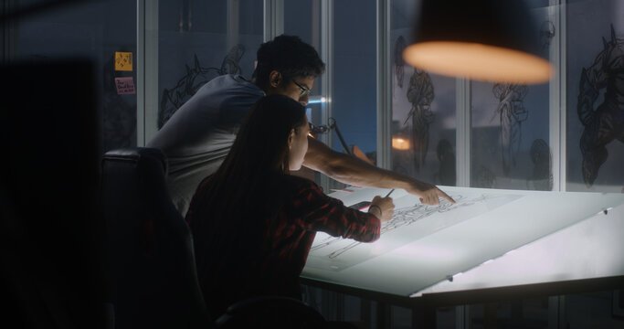 Graphic designers working on video game concept art