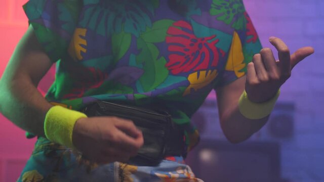 Funny young man from the 1980 1990 playing some air guitar. Vintage scene and background.