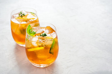 Iced tea with ice, mint and lemon. Refreshment cold summer drink.