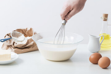 dough in glass plate and products for its preparation on  white background