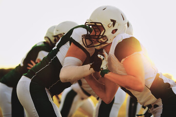 American football team doing defensive drills in the late aftern